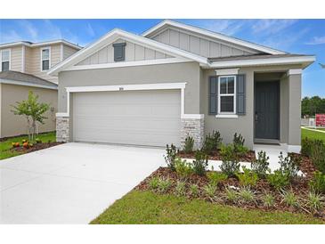 Charming single-story home with a two-car garage and well-manicured lawn at 804 Lake Dell Rd, Dundee, FL 33838