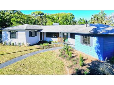 Inviting single-story home featuring a lush front yard and a charming walkway leading to the entrance at 905 W 11Th Ave, Mount Dora, FL 32757