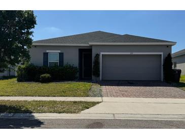 Charming single-story home featuring a well-maintained lawn and a two-car garage at 209 Citrus Pointe Dr, Haines City, FL 33844