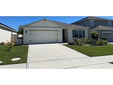 Charming single-story home with a well-manicured lawn and a two-car garage at 2439 White Lilly Dr, Kissimmee, FL 34747