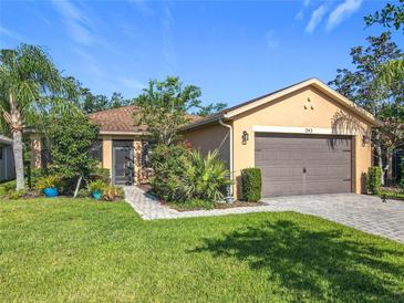 Charming single-story home with a well-manicured lawn and a two-car garage at 343 Scripps Ranch Rd, Poinciana, FL 34759