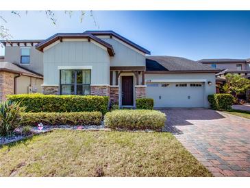 Charming single-Gathering home with well-maintained landscaping, brick driveway, and a two-car garage at 5118 Tiber Way, St Cloud, FL 34771