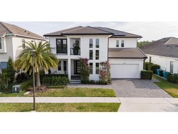 Charming two-story home with a well-manicured lawn, elegant landscaping, and an attached two-car garage at 6953 Broglie St, Orlando, FL 32827