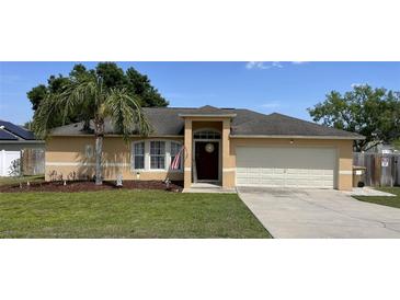 Charming single-story home with well-maintained lawn and a delightful palm tree at 1102 Peregrine St, Groveland, FL 34736