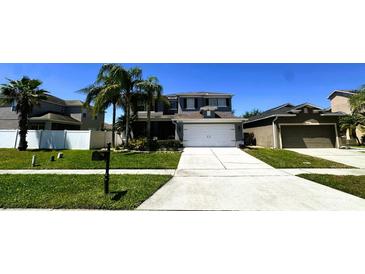 Well-maintained two story home featuring a manicured lawn and symmetrical landscaping for enhanced curb appeal at 14963 Braywood Trl, Orlando, FL 32824