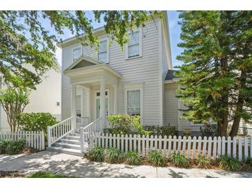 Charming two-story home featuring a welcoming front porch and a well-maintained picket fence at 212 Ficus St, Celebration, FL 34747