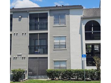 Three story condo building with screened in patios and handicap parking at 2130 Cascades Blvd # 108, Kissimmee, FL 34741