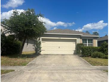 Charming home featuring a two-car garage and a well-manicured lawn at 219 Duke Dr, Deland, FL 32724