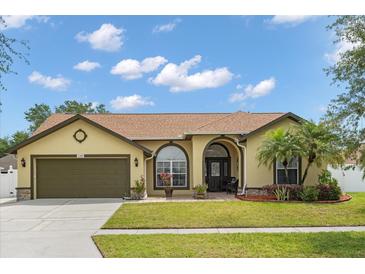 Charming one-story home with a well-manicured lawn, inviting entrance, and a two-car garage at 2289 Jessica Ln, Kissimmee, FL 34744