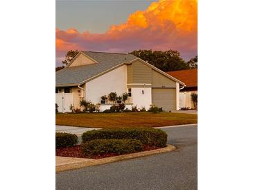 Charming single-Gathering home featuring a well-manicured lawn, flower boxes, and a two-car garage at 2615 Autumn Green Dr, Orlando, FL 32822