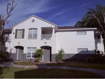 Charming two-story condo with gray doors and a cozy balcony on a sunny day at 4328 S Kirkman Rd # 1, Orlando, FL 32811