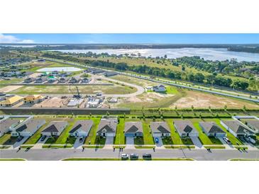 New construction community with stunning aerial views of homes, landscaping, and surrounding lakes at 452 Burnham Cir, Auburndale, FL 33823