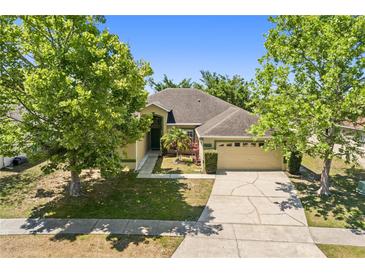 Charming single-story home with a well-manicured lawn and mature trees in a desirable neighborhood at 5365 Dahlia Reserve Dr, Kissimmee, FL 34758