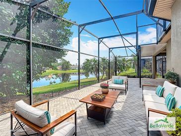 Enjoy a luxurious outdoor living space with screened patio overlooking the serene lake view at 567 Villa Park Rd, Kissimmee, FL 34759