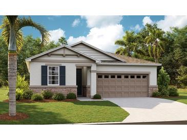 Charming single-story home featuring a two-car garage, stone accents, and well-manicured lawn at 1003 Cloud Ridge Ct, Mount Dora, FL 32757
