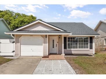 Charming single-story home with a one-car garage, complemented by a well-maintained yard and inviting front entrance at 1208 Roma Ct, Orlando, FL 32825