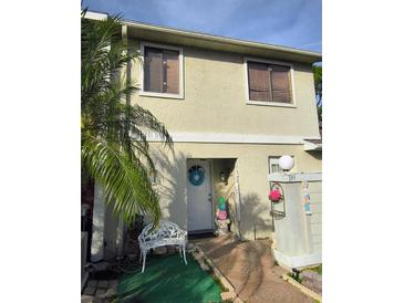 Charming home with a front yard decorated with Easter-themed decor and palm trees at 135 Pine Island Cir, Kissimmee, FL 34743