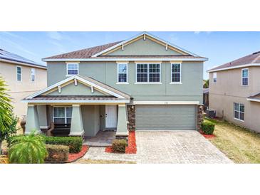 Charming two-story home with a well-manicured front yard and a two-car garage at 238 Granada Ave, Davenport, FL 33837