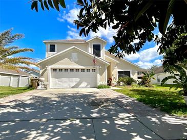 Charming two-story home featuring an attached two-car garage, neat landscaping, and a welcoming driveway at 2511 Balmoral Dr, Kissimmee, FL 34744