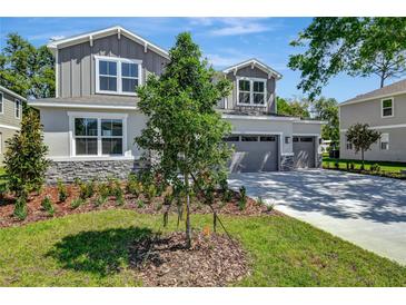 Beautiful two-story home with a three-car garage, landscaped front yard, and stone accents at 3773 Deer Ridge Dr, Mount Dora, FL 32757