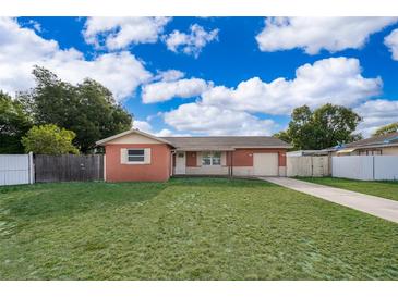 Charming one-story home featuring a lush green lawn and a well-maintained exterior at 1007 Maya Ave, Orlando, FL 32822