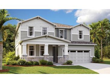 Charming two-story home features a stone and siding facade, complemented by well-manicured lawn and a two-car garage at 1067 Cloud Ridge Ct, Mount Dora, FL 32757