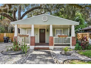 Charming home featuring a cozy front porch with brick accents, flower boxes and a landscaped front yard at 1104 E Anderson St, Orlando, FL 32801