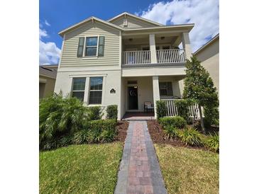 Charming two-story home with a cozy front porch and a well-maintained landscaped yard at 16043 Scarpetta St, Winter Garden, FL 34787