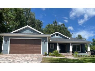 Charming single-story home with a two-car garage and a covered porch at 2943 Annalee Rd, St Cloud, FL 34771