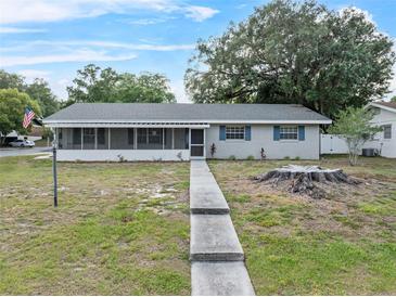 Charming single-story home with a screened-in porch and walkway at 301 Lake Ned Rd, Winter Haven, FL 33884