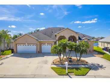 Beautiful home featuring a three-car garage, lovely landscaping, and a welcoming facade at 3181 Bayview Ln, St Cloud, FL 34772