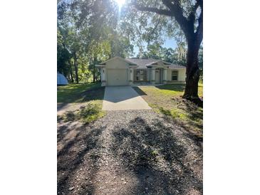 Charming single-story home with a welcoming front yard and attached garage at 7431 Cr 629, Bushnell, FL 33513