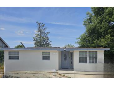 Charming single-story home featuring a gray front door and freshly painted white exterior at 924 Ferndell Rd, Orlando, FL 32808