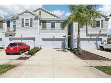 Charming townhome with an attached garage and a well-manicured lawn, perfect for suburban living at 12379 Turtle Grass Dr, Orlando, FL 32824