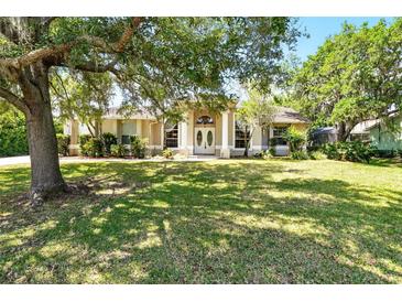 Charming one-story home with well-manicured lawn and mature trees providing ample shade at 2374 Eagle Trace Dr, Kissimmee, FL 34746