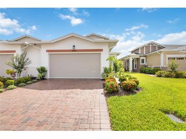 Charming villa featuring a red brick driveway and lush landscaping at 2503 Yellow Brick Rd, St Cloud, FL 34772