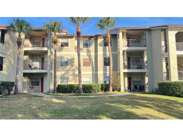 Multi-story condo complex with palm trees and well-maintained landscaping at 3038 Parkway Blvd # 204, Kissimmee, FL 34747