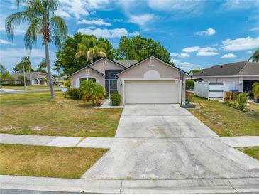 Charming single-story home with a two-car garage, mature landscaping, and basketball hoop at 3160 Santa Cruz Dr, Kissimmee, FL 34746