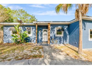 Charming blue single-story home with mature landscaping and inviting front entrance at 407 S Lakemont Ave, Winter Park, FL 32792