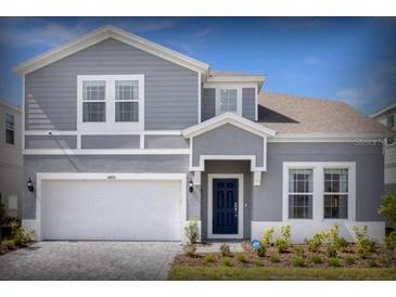 Charming two-story home with a well-manicured lawn and attached two-car garage at 4473 Kaipo Rd, Davenport, FL 33897