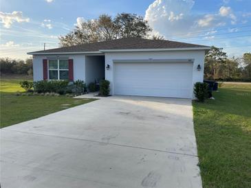 Charming one-story home with a spacious two-car garage and well-manicured lawn at 505 Peace Way, Poinciana, FL 34759