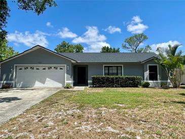 Charming single-story home with a well-maintained lawn and a two-car garage, perfect for suburban living at 1561 Cypress Woods Cir, St Cloud, FL 34772