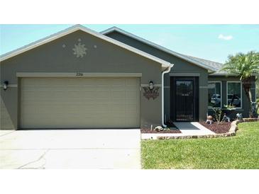 Charming single-story home features a neutral color scheme, two car garage and manicured lawn at 2206 Hunters Greene Dr, Lakeland, FL 33810