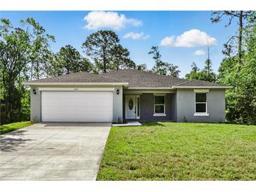 Charming single-story home with a manicured lawn and two car garage at 225 Starling Ct, Kissimmee, FL 34759