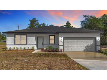 Charming one-story home featuring a fresh exterior, neat landscaping, and an attached two-car garage at 2639 Sw 162Nd Street Rd, Ocala, FL 34473