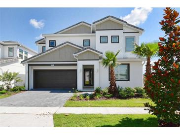 Beautiful two-story home featuring a modern design, a well-maintained yard, and a two-car garage at 2649 Calistoga Ave, Kissimmee, FL 34741