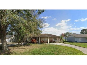 Charming single-story home with a well-maintained lawn and a driveway at 2947 Larson St, Kissimmee, FL 34741