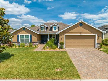 Charming single-story home featuring a well-manicured lawn, beautiful landscaping, and an inviting front entrance at 3101 Drema Dr, St Cloud, FL 34769