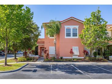Charming two-story home with a vibrant exterior, a well-manicured lawn, and a beautiful palm tree at 4722 Flagler Beach Way, Kissimmee, FL 34746