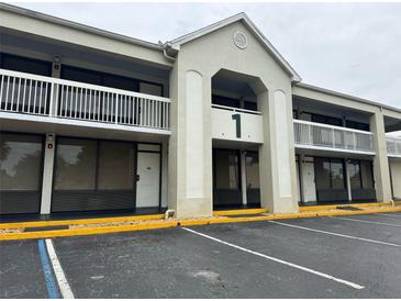 Exterior view of a building featuring a large number 1 and a balcony at 5245 W Irlo Bronson Memorial Hwy # 210, Kissimmee, FL 34746